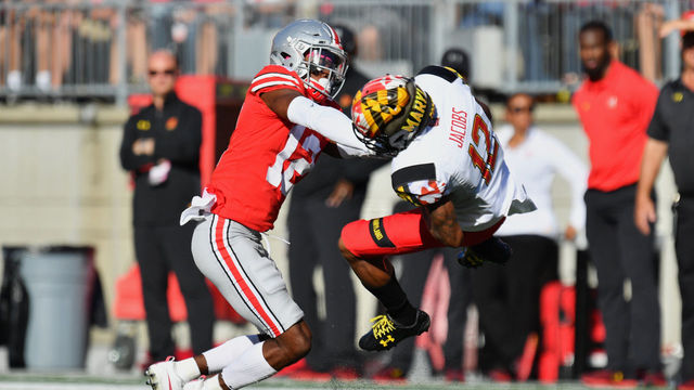 COLUMBUS, OH - OCTOBER 7: Denzel Ward #12 of the Ohio State Buckeyes hits Taivon Jacobs #12 of the Maryland Terrapins after a reception in the first quarter at Ohio Stadium on October 7, 2017 in Columbus, Ohio. Ward was ejected from the game after being assessed a targeting penalty for the hit.