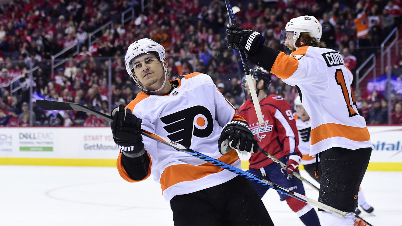 WASHINGTON, DC - JANUARY 21: Travis Konecny #11 of the Philadelphia Flyers celebrates with his teammates after scoring the game-winning goal in overtime against the Washington Capitals at Capital One Arena on January 21, 2018 in Washington, DC.