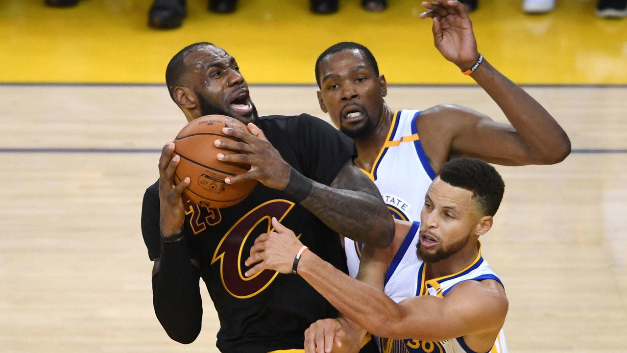 OAKLAND, CA - JUNE 12: LeBron James #23 of the Cleveland Cavaliers is defended by Kevin Durant #35 and Stephen Curry #30 of the Golden State Warriors during the second half in Game 5 of the 2017 NBA Finals at ORACLE Arena on June 12, 2017 in Oakland, California.