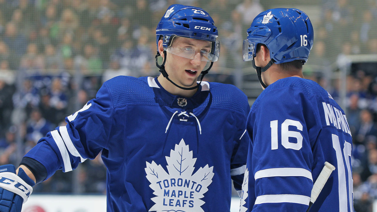 TORONTO,ON - JANUARY 16: Travis Dermott #23 of the Toronto Maple Leafs chats with teammate Mitchell Marner #16 prior to a puck drop against the St.Louis Blues during an NHL game at the Air Canada Centre on January 16, 2018 in Toronto, Ontario, Canada. The Blues defeated the Maple Leafs 2-1 in overtime.