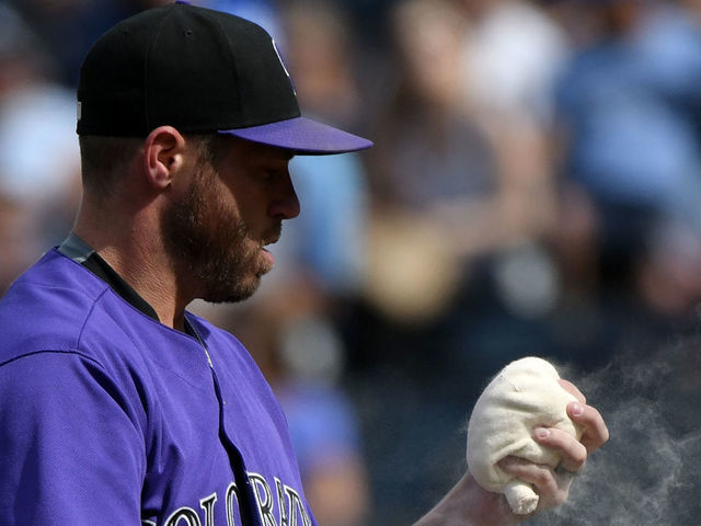 KANSAS CITY, MO - AUGUST 24: Greg Holland #56 of the Colorado Rockies uses the rosin bag before throwing against the Kansas City Royals in the ninth inning at Kauffman Stadium on August 24, 2017 in Kansas City, Missouri.