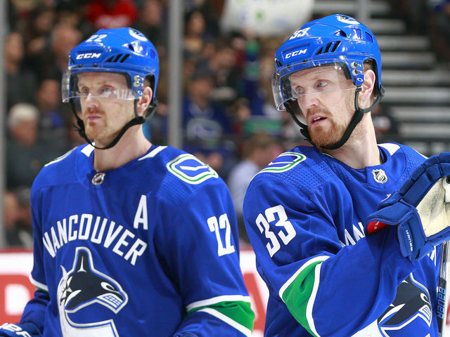 VANCOUVER, BC - JANUARY 2: Henrik Sedin #33 and Daniel Sedin #22 of the Vancouver Canucks skate up ice during their NHL game against the Anaheim Ducks at Rogers Arena January 2, 2018 in Vancouver, British Columbia, Canada. 'n