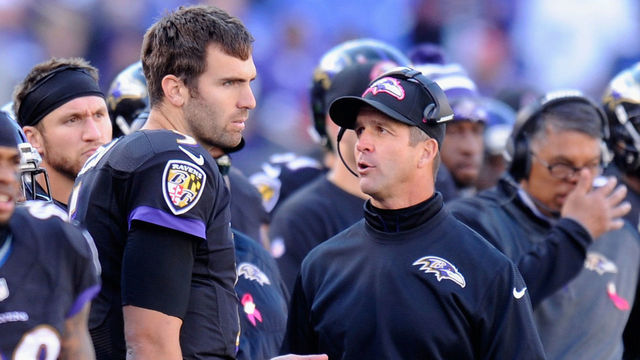 BALTIMORE, MD - OCTOBER 19: Head coach John Harbaugh of the Baltimore Ravens speaks with quarterback Joe Flacco #5 of the Baltimore Ravens on the sideline during the second half of a game against the Atlanta Falcons at M&T Bank Stadium on October 19, 2014 in Baltimore, Maryland.