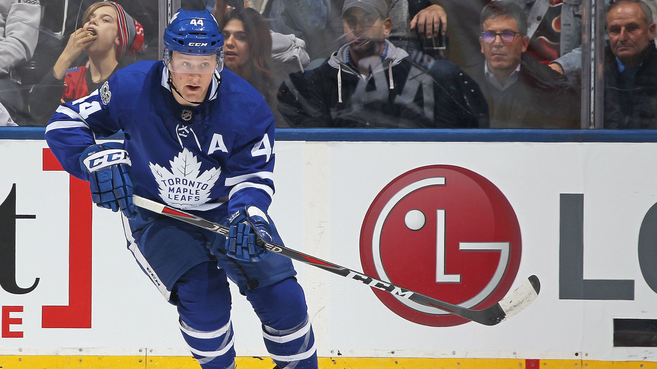 TORONTO,ON - DECEMBER 6: Morgan Rielly #44 of the Toronto Maple Leafs passes the puck up ice against the Calgary Flames during an NHL game at the Air Canada Centre on December 6, 2017 in Toronto, Ontario, Canada. The Maple Leafs defeated the Flames 2-1 in an overtime shoot-out.