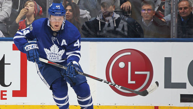 TORONTO,ON - DECEMBER 6: Morgan Rielly #44 of the Toronto Maple Leafs passes the puck up ice against the Calgary Flames during an NHL game at the Air Canada Centre on December 6, 2017 in Toronto, Ontario, Canada. The Maple Leafs defeated the Flames 2-1 in an overtime shoot-out.