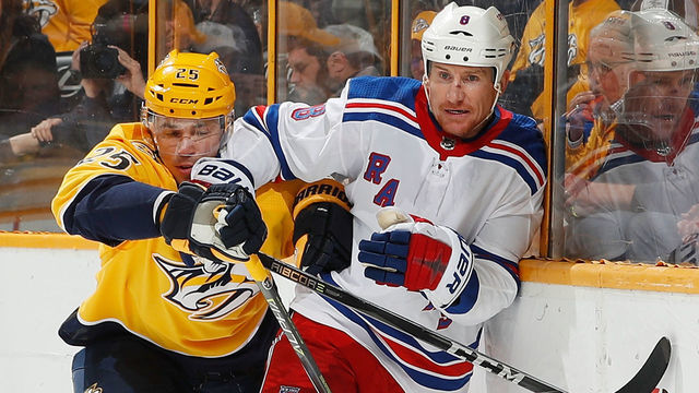 NASHVILLE, TN - FEBRUARY 3: Alexei Emelin #25 of the Nashville Predators battles along the boards against Cody McLeod #8 of the New York Rangers during an NHL game at Bridgestone Arena on February 3, 2018 in Nashville, Tennessee.