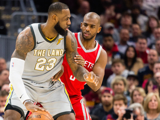 CLEVELAND, OH - FEBRUARY 3: LeBron James #23 of the Cleveland Cavaliers tries to drive around Chris Paul #3 of the Houston Rockets during the first half at Quicken Loans Arena on February 3, 2018 in Cleveland, Ohio.
