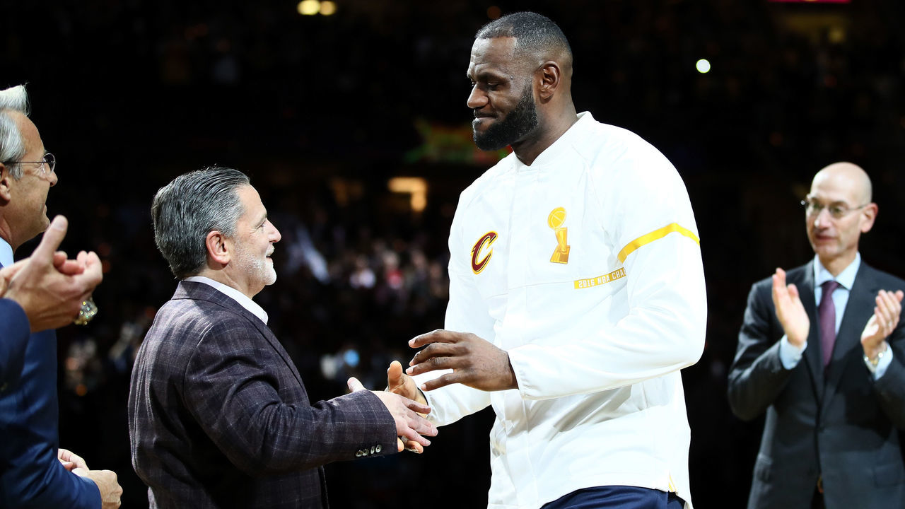 CLEVELAND, OH - OCTOBER 25: LeBron James #23 of the Cleveland Cavaliers recieves his championship ring from owner Dan Gilbert before the game against the New York Knicks at Quicken Loans Arena on October 25, 2016 in Cleveland, Ohio.