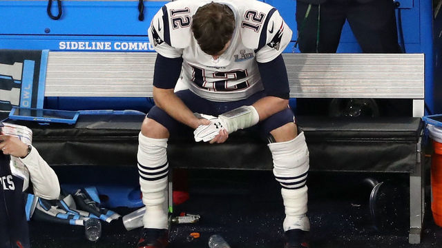 MINNEAPOLIS, MN - FEBRUARY 04: Tom Brady #12 of the New England Patriots sits on the bench after having the ball stripped by Brandon Graham #55 of the Philadelphia Eagles late in the fourth quarter in Super Bowl LII at U.S. Bank Stadium on February 4, 2018 in Minneapolis, Minnesota.