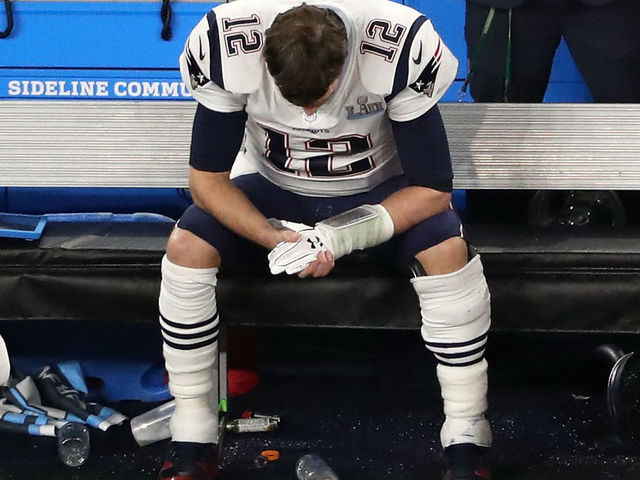 MINNEAPOLIS, MN - FEBRUARY 04: Tom Brady #12 of the New England Patriots sits on the bench after having the ball stripped by Brandon Graham #55 of the Philadelphia Eagles late in the fourth quarter in Super Bowl LII at U.S. Bank Stadium on February 4, 2018 in Minneapolis, Minnesota.