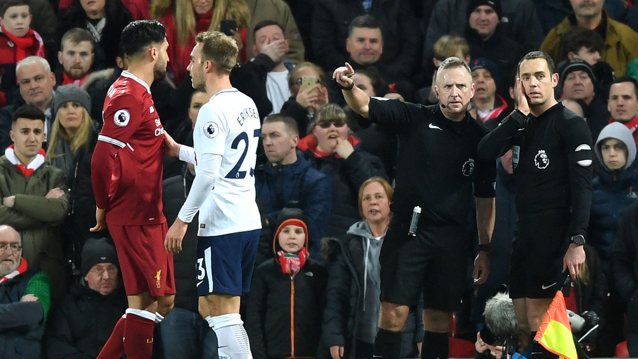 LIVERPOOL, ENGLAND - FEBRUARY 04: Refree Jonathan Moss consults with his assistant referee over a penalty decision during the Premier League match between Liverpool and Tottenham Hotspur at Anfield on February 4, 2018 in Liverpool, England.