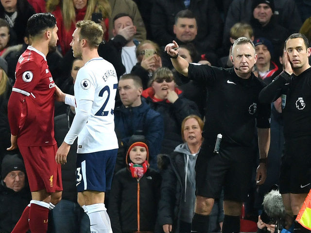 LIVERPOOL, ENGLAND - FEBRUARY 04: Refree Jonathan Moss consults with his assistant referee over a penalty decision during the Premier League match between Liverpool and Tottenham Hotspur at Anfield on February 4, 2018 in Liverpool, England.
