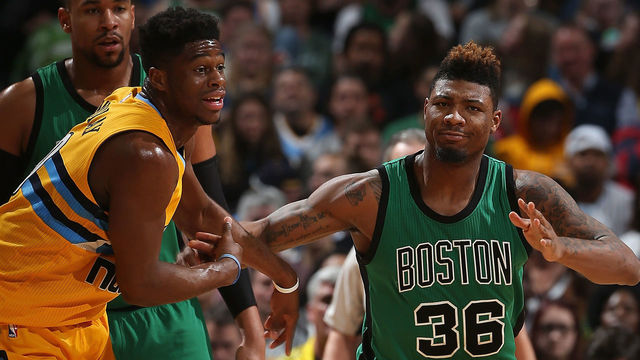 DENVER, CO - FEBRUARY 21: Emmanuel Mudiay #0 of the Denver Nuggets and Marcus Smart #36 of the Boston Celtics pursue the ball at Pepsi Center on February 21, 2016 in Denver, Colorado. The Celtics defeated the Nuggets 121-101.