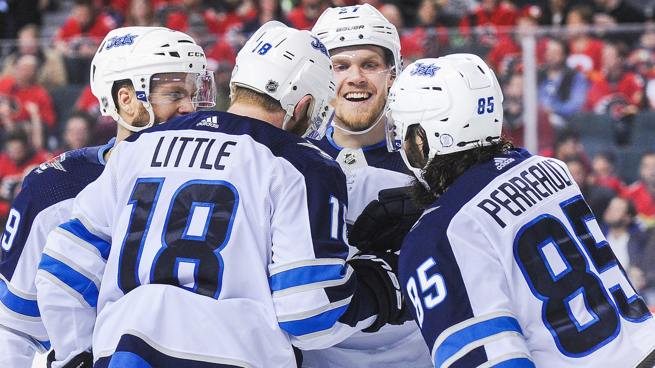 CALGARY, AB - JANUARY 20: Bryan Little #18 (L) of the Winnipeg Jets celebrates with his teammates after scoring against the Calgary Flames during an NHL game at Scotiabank Saddledome on January 20, 2018 in Calgary, Alberta, Canada.