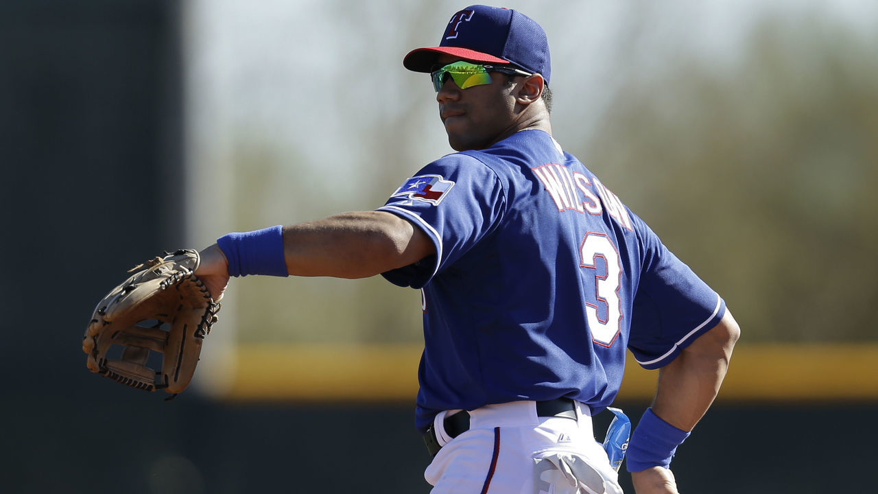 SURPRISE, AZ - MARCH 03: Russell Wilson #3 of the Texas Rangers throws in the outfield during a work out before the game against the Cleveland Indians at Surprise Stadium on March 03, 2014 in Surprise, Arizona.