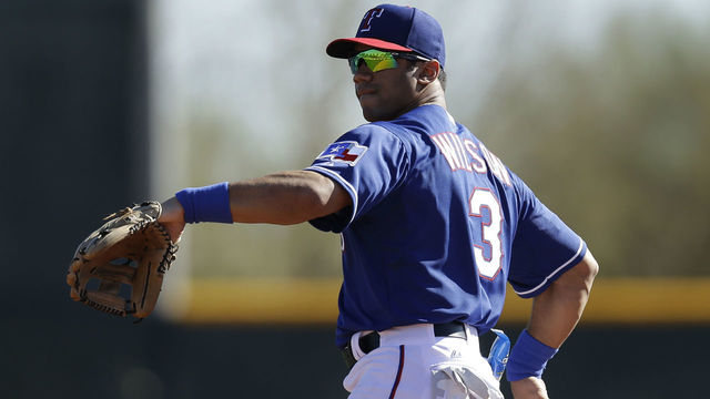 SURPRISE, AZ - MARCH 03: Russell Wilson #3 of the Texas Rangers throws in the outfield during a work out before the game against the Cleveland Indians at Surprise Stadium on March 03, 2014 in Surprise, Arizona.