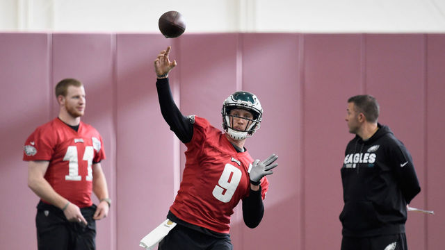 BLOOMINGTON, MN - JANUARY 31: Carson Wentz #11 and quarterbacks coach John DeFilippo of the Philadelphia Eagles looks on as teammate Nick Foles #9 passes the ball during Super Bowl LII practice on January 31, 2018 at the University of Minnesota in Minneapolis, Minnesota. The Philadelphia Eagles will face the New England Patriots in Super Bowl LII on February 4th.