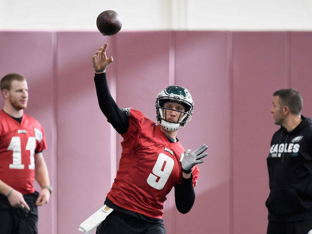 BLOOMINGTON, MN - JANUARY 31: Carson Wentz #11 and quarterbacks coach John DeFilippo of the Philadelphia Eagles looks on as teammate Nick Foles #9 passes the ball during Super Bowl LII practice on January 31, 2018 at the University of Minnesota in Minneapolis, Minnesota. The Philadelphia Eagles will face the New England Patriots in Super Bowl LII on February 4th.