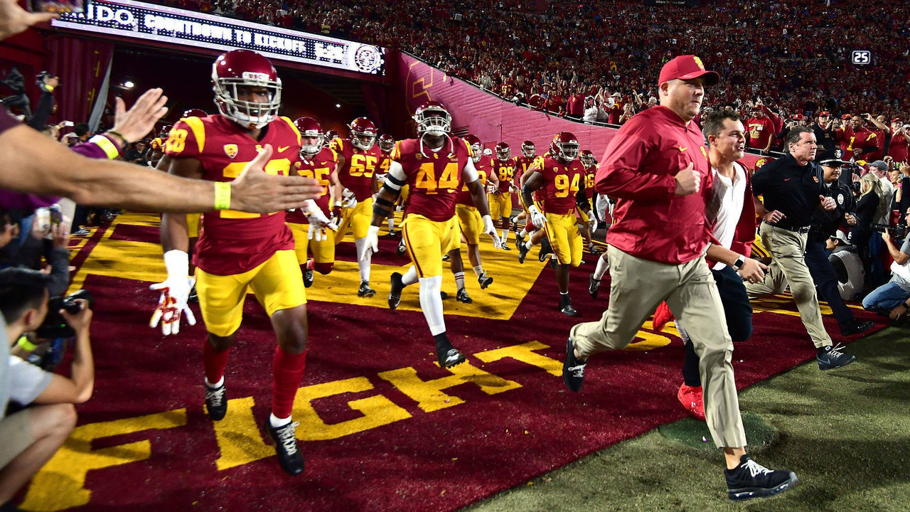 LOS ANGELES, CA - NOVEMBER 18: Head coach Clay Helton of the USC Trojans leads his team on to the field to face the UCLA Bruins at Los Angeles Memorial Coliseum on November 18, 2017 in Los Angeles, California.