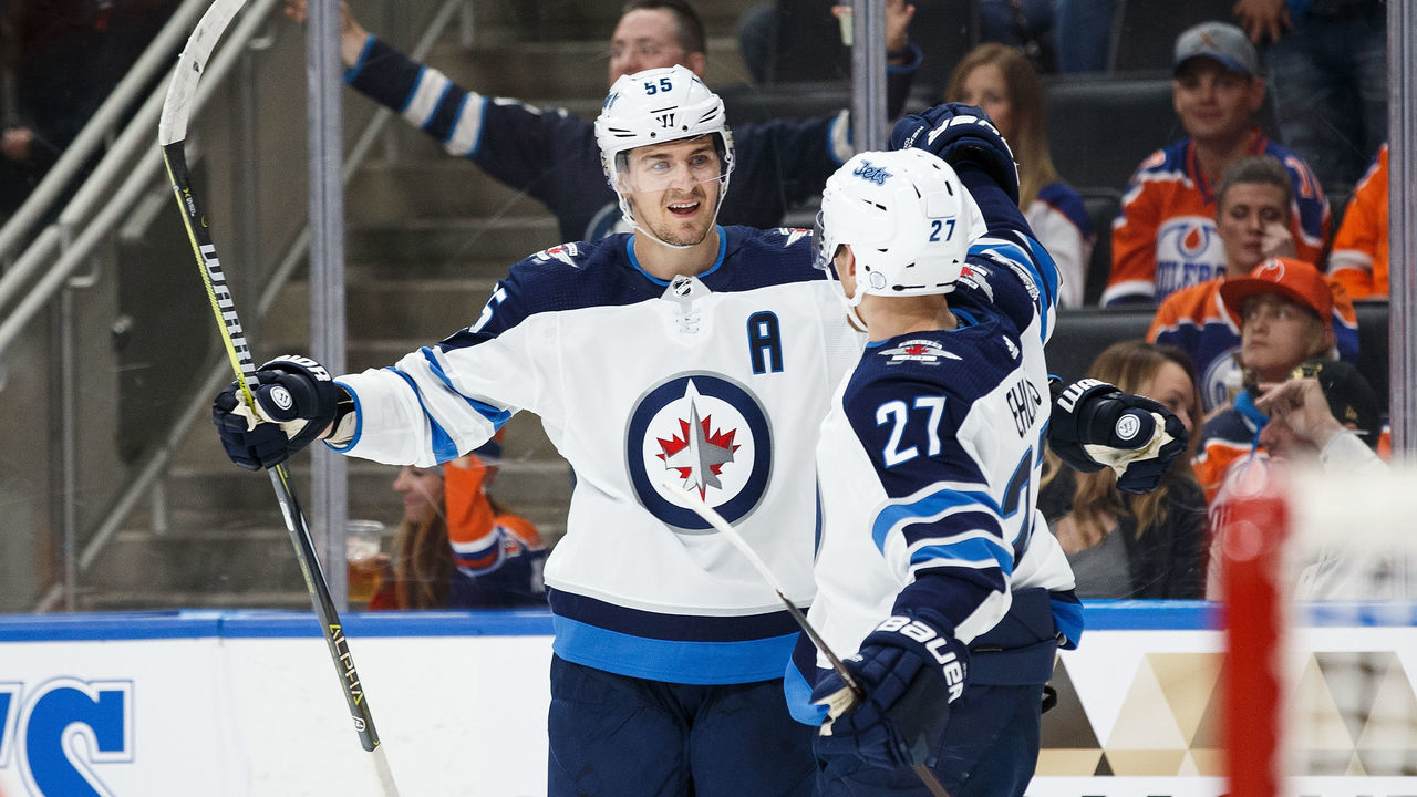 EDMONTON, AB - OCTOBER 09: Mark Scheifele #55 and Nikolaj Ehlers #27 of the Winnipeg Jets celebrate Ehlers' hat trick against the Edmonton Oilers at Rogers Place on October 9, 2017 in Edmonton, Canada.