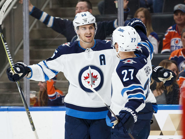 EDMONTON, AB - OCTOBER 09: Mark Scheifele #55 and Nikolaj Ehlers #27 of the Winnipeg Jets celebrate Ehlers' hat trick against the Edmonton Oilers at Rogers Place on October 9, 2017 in Edmonton, Canada.