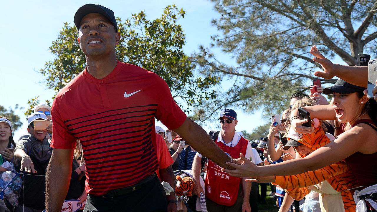 SAN DIEGO, CA - JANUARY 28: Tiger Woods high fives a fan during the final round of the Farmers Insurance Open at Torrey Pines South on January 28, 2018 in San Diego, California.