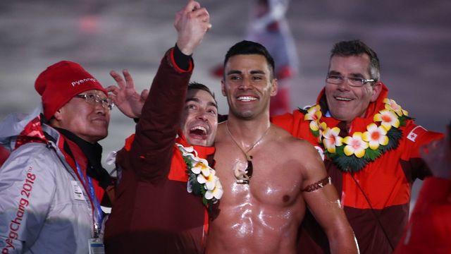 Tonga's flagbearer Pita Taufatofua (C-R) takes a selfie as his country's delegation parades during the opening ceremony of the Pyeongchang 2018 Winter Olympic Games at the Pyeongchang Stadium on February 9, 2018. / AFP PHOTO / POOL / -