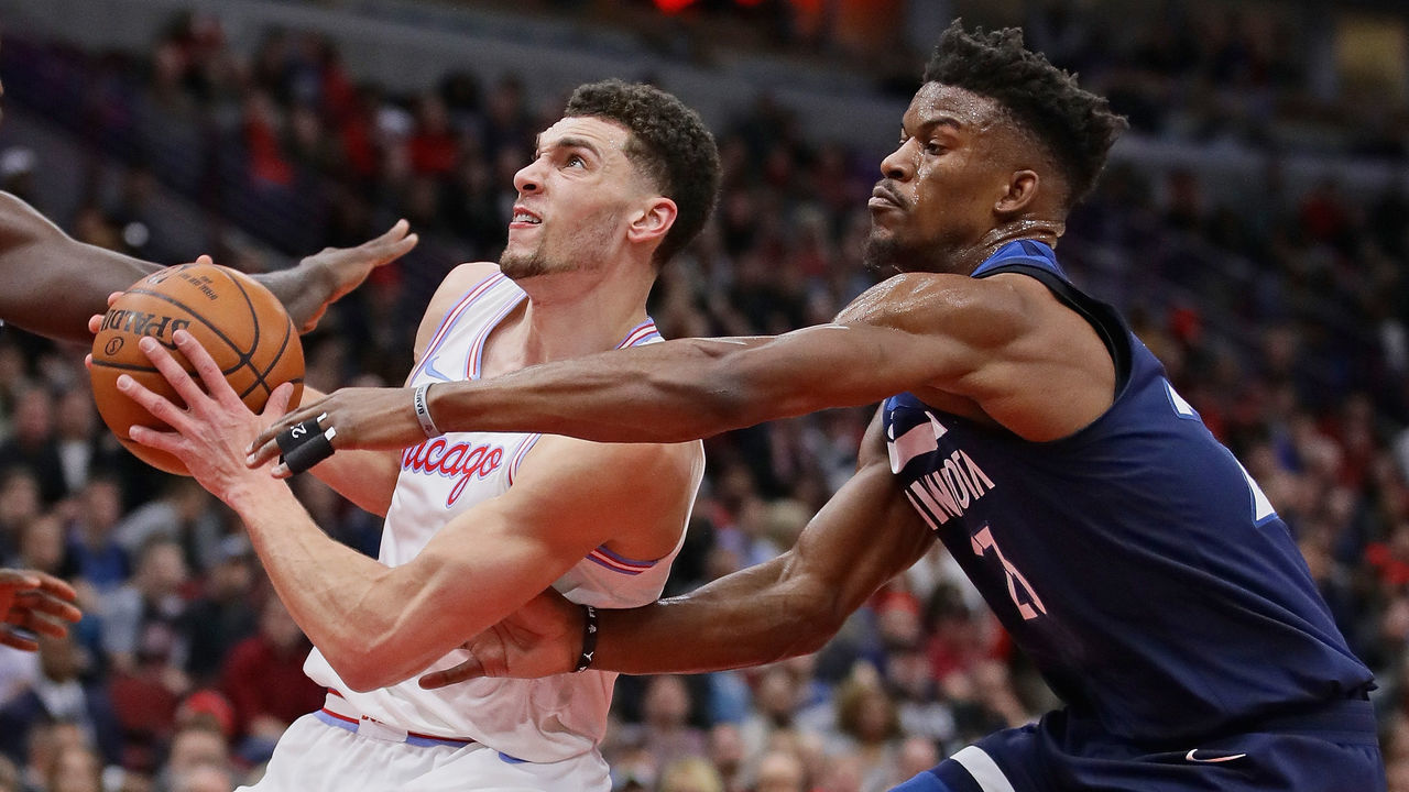 CHICAGO, IL - FEBRUARY 09: Zach LaVine #8 of the Chicago Bulls drives past Jimmy Butler #23 of the Minnesota Timberwolves at the United Center on February 9, 2018 in Chicago, Illinois.