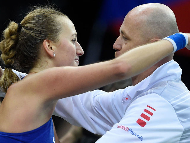 Czech Petra Kvitova celebrates with captain of Czech fed Cup team Petr Pala (R) after defeated Swiss Viktorija Golubic (Unseen) in the first round of the International Tennis Federation Fed Cup match between Czech Republic vs Switzerland on February 10, 2018 in Prague. / AFP PHOTO / Michal Cizek