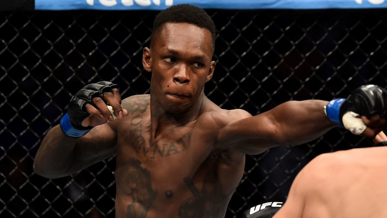 PERTH, AUSTRALIA - FEBRUARY 11: (L-R) Israel Adesanya of Nigeria punches Rob Wilkinson of Australia in their middleweight bout during the UFC 221 event at Perth Arena on February 11, 2018 in Perth, Australia.
