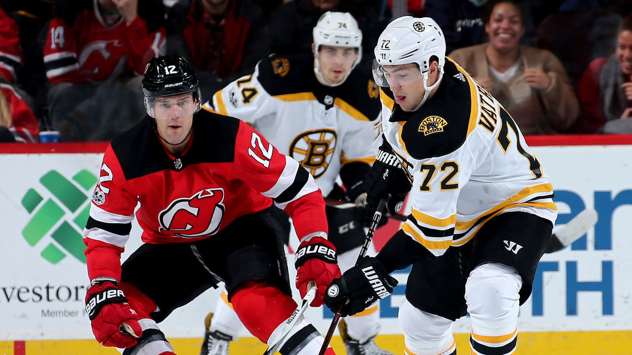 NEWARK, NJ - NOVEMBER 22: Frank Vatrano #72 of the Boston Bruins takes the puck as Ben Lovejoy #12 of the New Jersey Devils defends on November 22, 2017 at Prudential Center in Newark, New Jersey.
