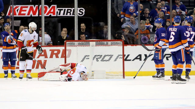NEW YORK, NY - FEBRUARY 11: Mike Smith #41 of the Calgary Flames lays on the ground after being injured with 1.1 seconds left in the third period against the New York Islanders during their game at Barclays Center on February 11, 2018 in the Brooklyn borough of New York City.