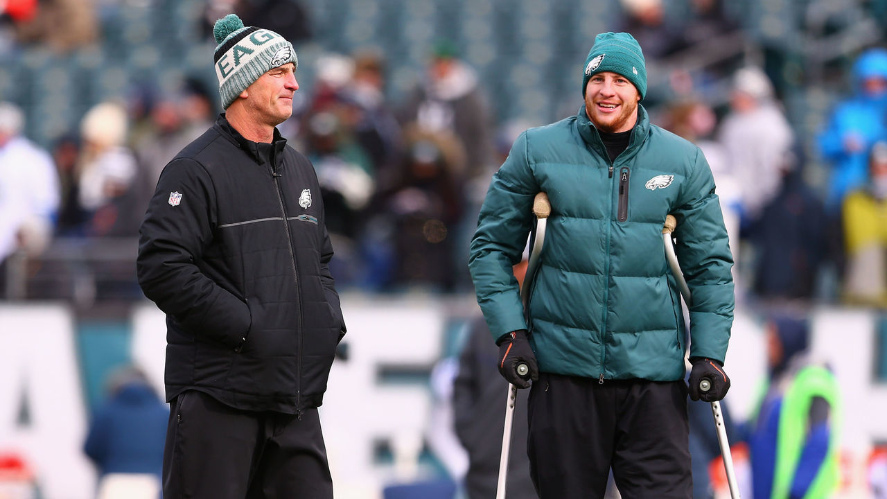 PHILADELPHIA, PA - DECEMBER 31: Injured quarterback Carson Wentz #11 (R) talks with Offensive Coordinator Frank Reich (L) before the game against the Dallas Cowboys at Lincoln Financial Field on December 31, 2017 in Philadelphia, Pennsylvania.