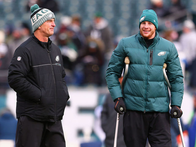 PHILADELPHIA, PA - DECEMBER 31: Injured quarterback Carson Wentz #11 (R) talks with Offensive Coordinator Frank Reich (L) before the game against the Dallas Cowboys at Lincoln Financial Field on December 31, 2017 in Philadelphia, Pennsylvania.