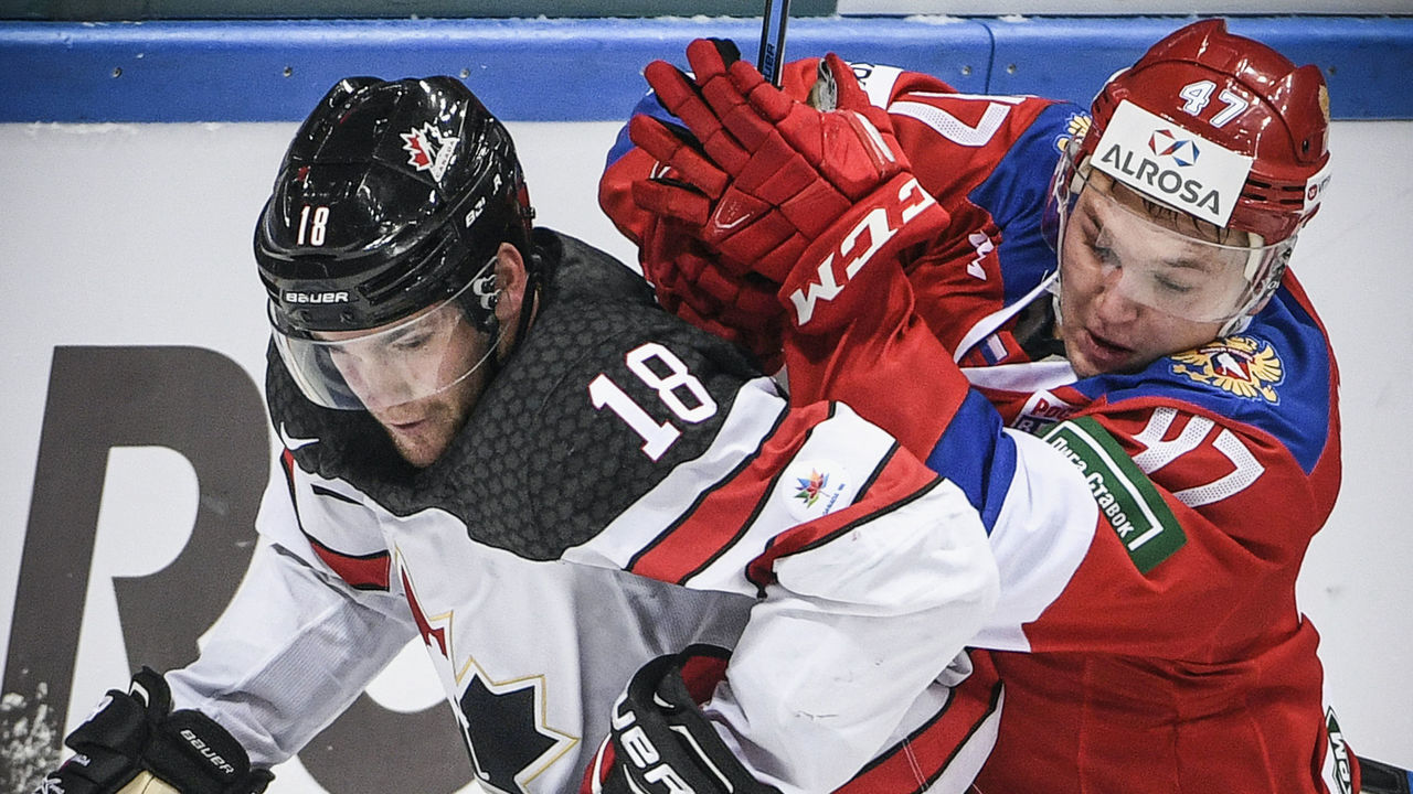 Russia's forward Kirill Kaprizov (R) vies for the puck with Canada's forward Linden Vey during the Channel One Cup of the Euro Hockey Tour ice hockey match between Canada and Russia in Moscow on December 16, 2017. / AFP PHOTO / Alexander NEMENOV