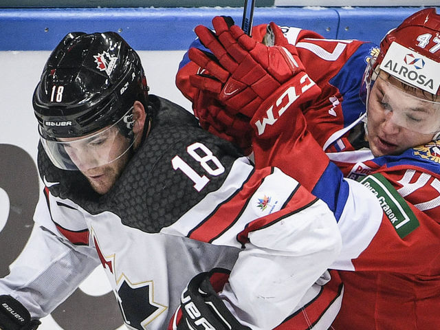 Russia's forward Kirill Kaprizov (R) vies for the puck with Canada's forward Linden Vey during the Channel One Cup of the Euro Hockey Tour ice hockey match between Canada and Russia in Moscow on December 16, 2017. / AFP PHOTO / Alexander NEMENOV