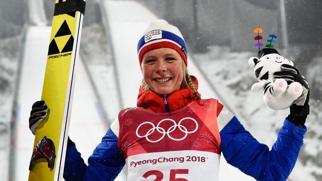 Gold medallist Norway's Maren Lundby celebrates on the podium during the victory ceremony following the women's normal hill individual ski jumping event during the Pyeongchang 2018 Winter Olympic Games on February 12, 2018, in Pyeongchang. / AFP PHOTO / Jonathan NACKSTRAND