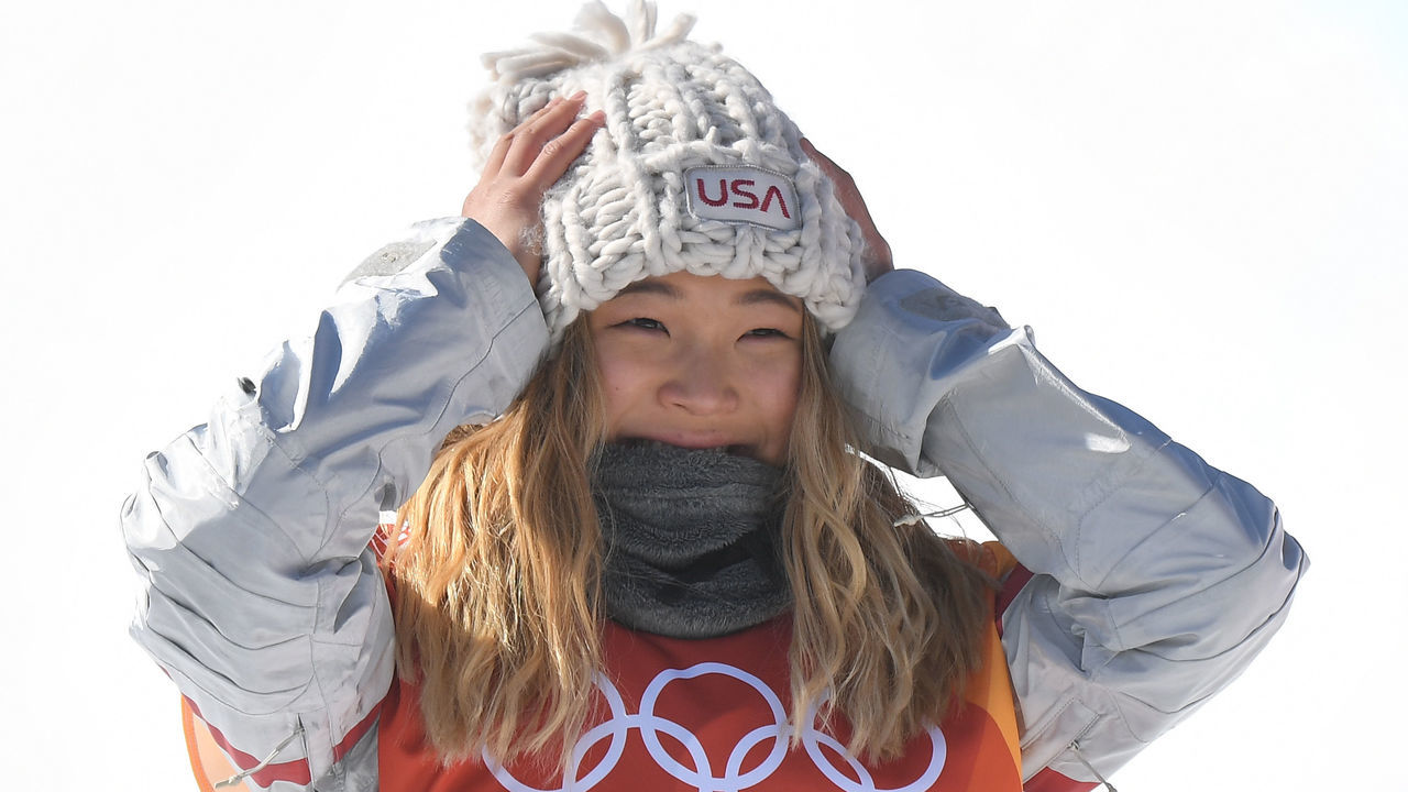 Gold medallist US Chloe Kim celebrates during the victory ceremony after the women's snowboard halfpipe final event at the Phoenix Park during the Pyeongchang 2018 Winter Olympic Games on February 13, 2018 in Pyeongchang. / AFP PHOTO / LOIC VENANCE