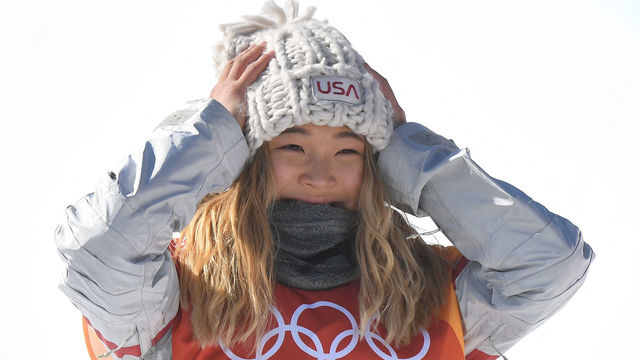 Gold medallist US Chloe Kim celebrates during the victory ceremony after the women's snowboard halfpipe final event at the Phoenix Park during the Pyeongchang 2018 Winter Olympic Games on February 13, 2018 in Pyeongchang. / AFP PHOTO / LOIC VENANCE