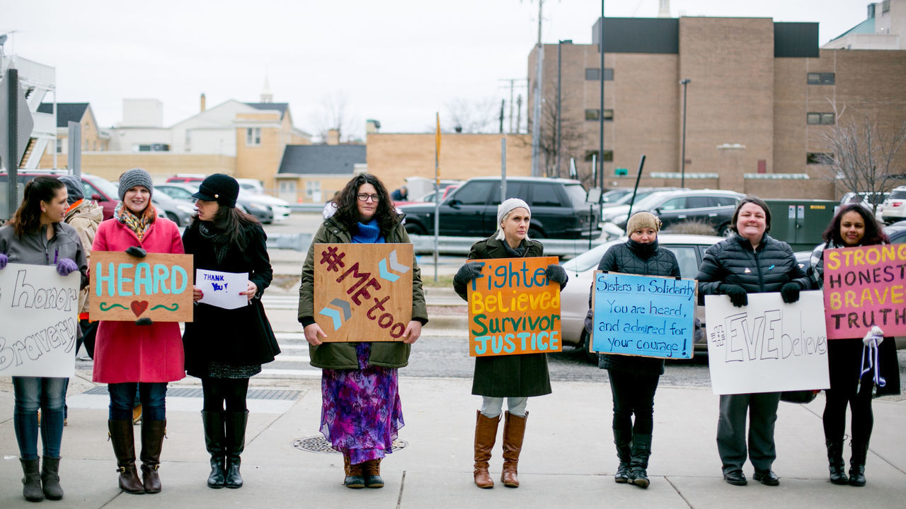 LANSING, MI - JANUARY 24: Women from the Michigan based victim advocacy groups End Violent Encounters and Firecracker Foundation cheer for women as they leave the courthouse after the sentencing of disgraced doctor Larry Nassar in Ingham County Circuit Court on January 24, 2018 in Lansing, Michigan. The former USA Gymnastics and Michigan State University doctor was sentenced to up to 175 years in prison for sexual assault after more than 150 women and girls confronted him in court and spoke of their abuse.