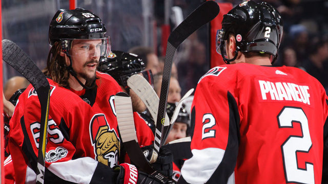 OTTAWA, ON - DECEMBER 4: Erik Karlsson #65 of the Ottawa Senators chats with Dion Phaneuf #2 during a break in a game against the New York Rangers at Canadian Tire Centre on December 4, 2017 in Ottawa, Ontario, Canada.