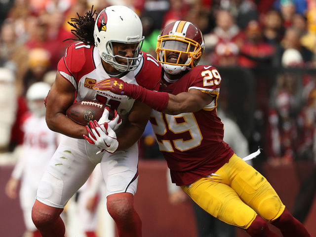 LANDOVER, MD - DECEMBER 17: Wide Receiver Larry Fitzgerald #11 of the Arizona Cardinals is tackled by cornerback Kendall Fuller #29 of the Washington Redskins in the first quarter at FedEx Field on December 17, 2017 in Landover, Maryland.