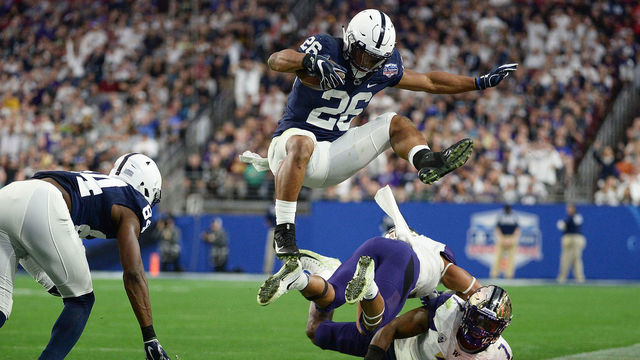 GLENDALE, AZ - DECEMBER 30: Running back Saquon Barkley #26 of the Penn State Nittany Lions leaps over defensive back Austin Joyner #4 and linebacker Keishawn Bierria #7 of the Washington Huskies during the second half of the PlayStation Fiesta Bowl at University of Phoenix Stadium on December 30, 2017 in Glendale, Arizona. The Penn State Nittany Lions won 35-28.