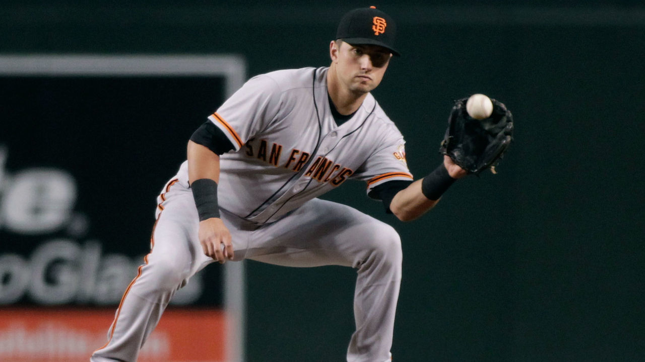 PHOENIX, AZ - SEPTEMBER 25: Joe Panik #12 of the San Francisco Giants fields a throw to second base during a MLB game against the Arizona Diamondbacks at Chase Field on September 25, 2017 in Phoenix, Arizona. The Giants defeated the Diamondbacks 9-2.