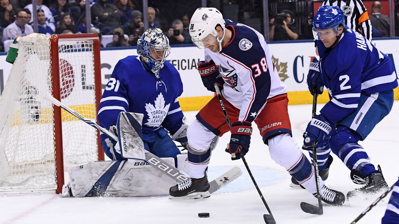TORONTO, ON - JANUARY 08: Columbus Blue Jackets Center Boone Jenner (38) controls the puck in front of Toronto Maple Leafs Goalie Frederik Andersen (31) and Defenceman Ron Hainsey (2)during the regular season NHL game between the Columbus Blue Jackets and Toronto Maple Leafs on January 8, 2018 at Air Canada Centre in Toronto, ON.