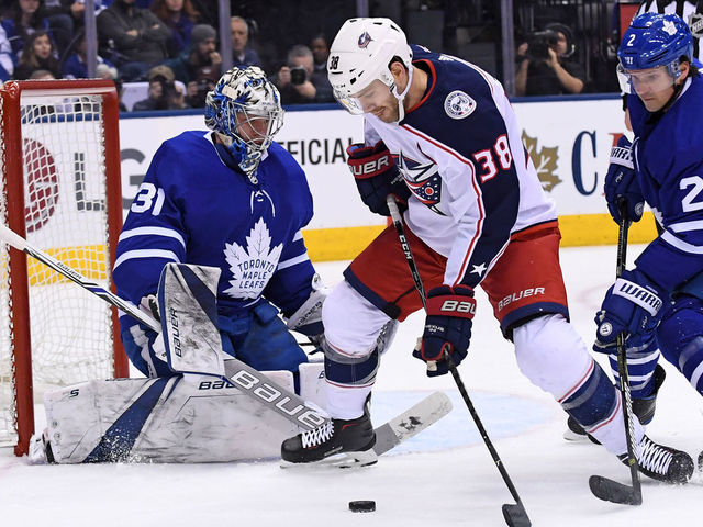 TORONTO, ON - JANUARY 08: Columbus Blue Jackets Center Boone Jenner (38) controls the puck in front of Toronto Maple Leafs Goalie Frederik Andersen (31) and Defenceman Ron Hainsey (2)during the regular season NHL game between the Columbus Blue Jackets and Toronto Maple Leafs on January 8, 2018 at Air Canada Centre in Toronto, ON.