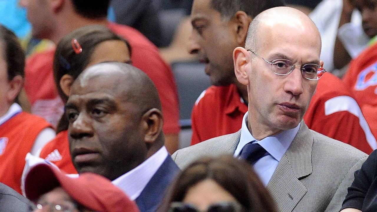 LOS ANGELES, CALIFORNIA MAY 11, 2014-NBA Comissioner Adam Silver, center, sits next to Magic Johnson, left, during the Clippers/ Thunder game Sunday at the Staples Center Sunday.