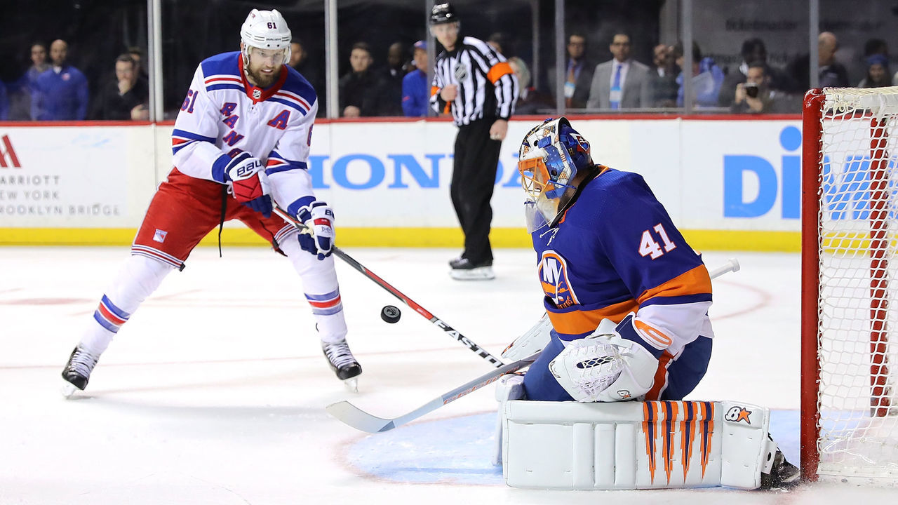 NEW YORK, NY - FEBRUARY 15: Jaroslav Halak #41 of the New York Islanders blocks a shot by Rick Nash #61 of the New York Rangers in the first period during their game at Barclays Center on February 15, 2018 in the Brooklyn borough of New York City.