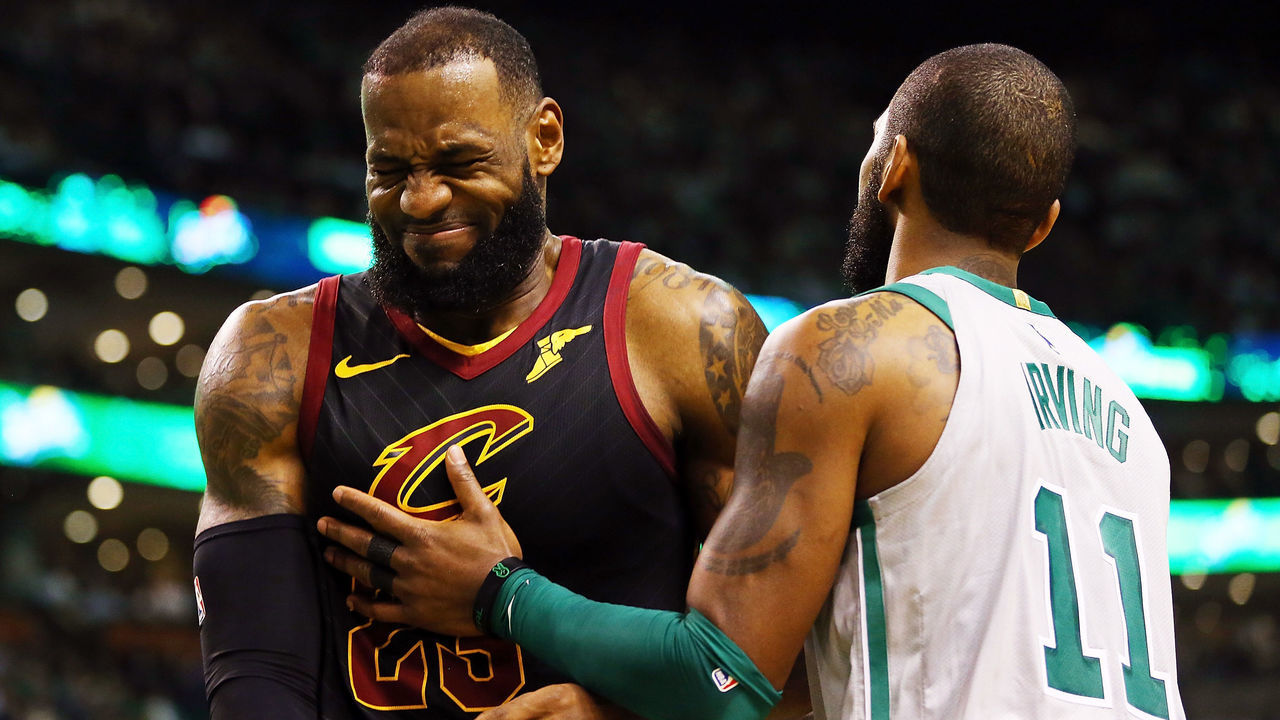 BOSTON, MA - FEBRUARY 11: Lebron James #23 of the Cleveland Cavaliers reacts with Kyrie Irving #11 of the Boston Celtics during the first quarter of a game at TD Garden on February 11, 2018 in Boston, Massachusetts.