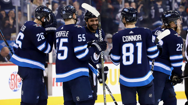 WINNIPEG, MB - FEBRUARY 16: Blake Wheeler #26, Mark Scheifele #55, Dustin Byfuglien #33, Kyle Connor #81 and Patrik Laine #29 of the Winnipeg Jets head to the bench after celebrating a second period goal against the Colorado Avalanche at the Bell MTS Place on February 16, 2018 in Winnipeg, Manitoba, Canada.